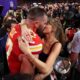 Travis Kelce and Taylor Swift kiss after the 2024 Super Bowl