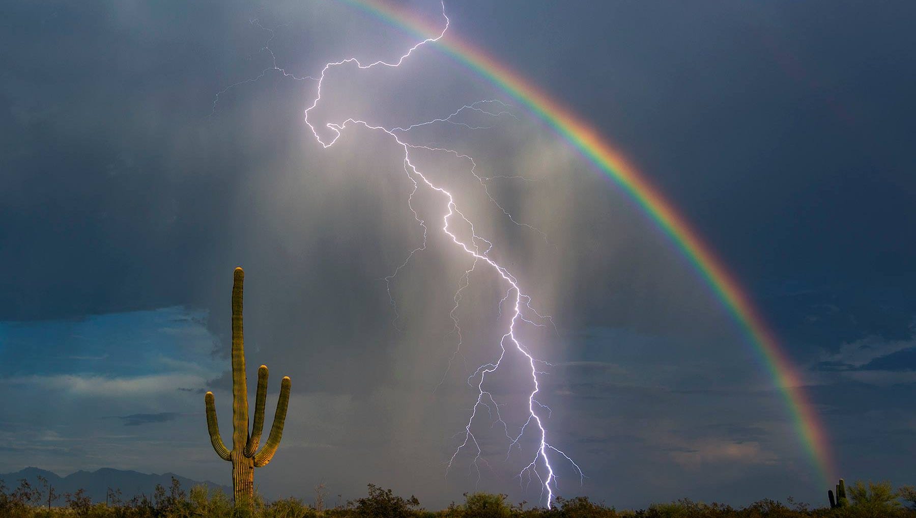 Lightnings and Rainbows: Lightning strikes and a rainbow forms during Minnesota storm